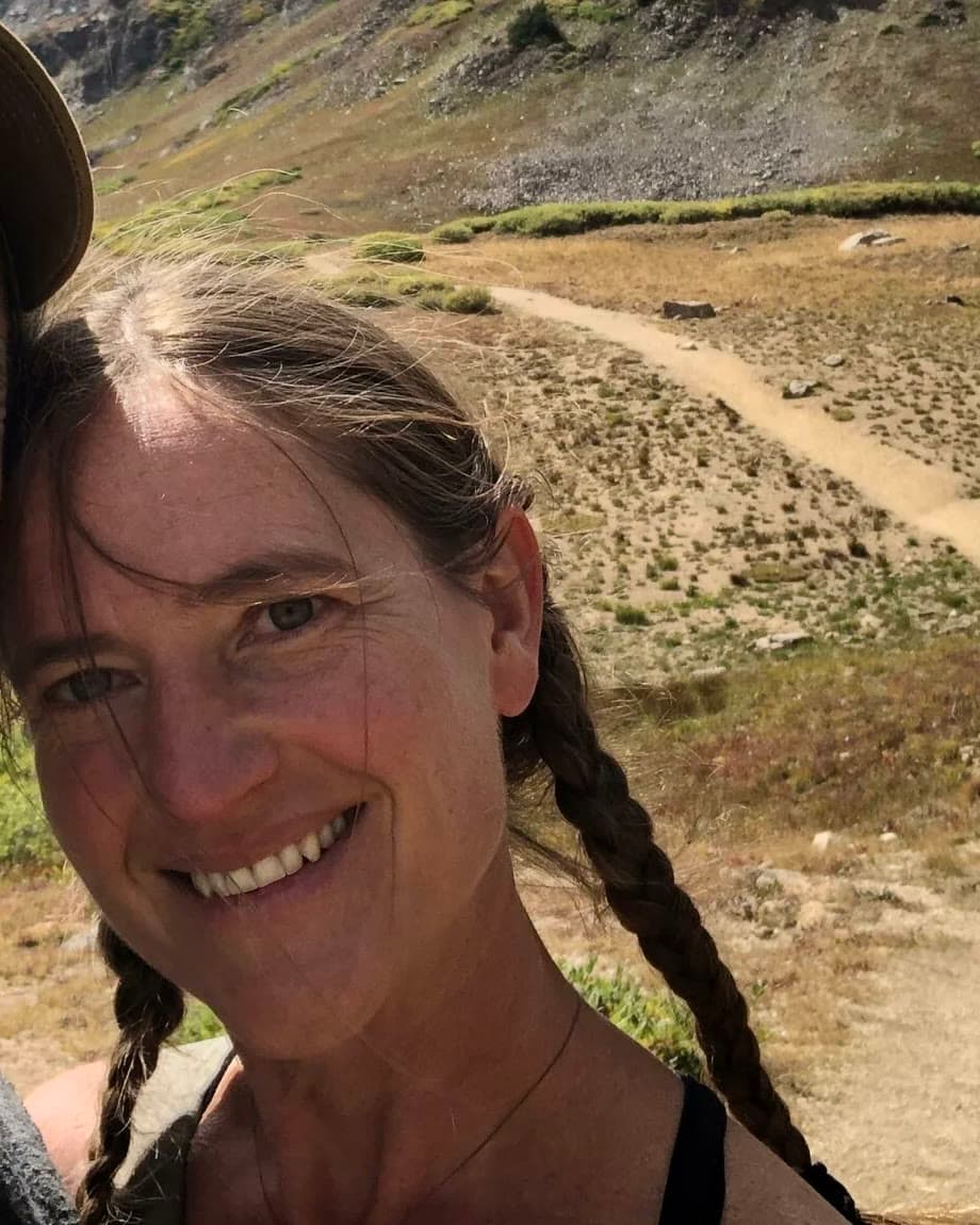 Ms. Rachel smiling in the mountains above Golden