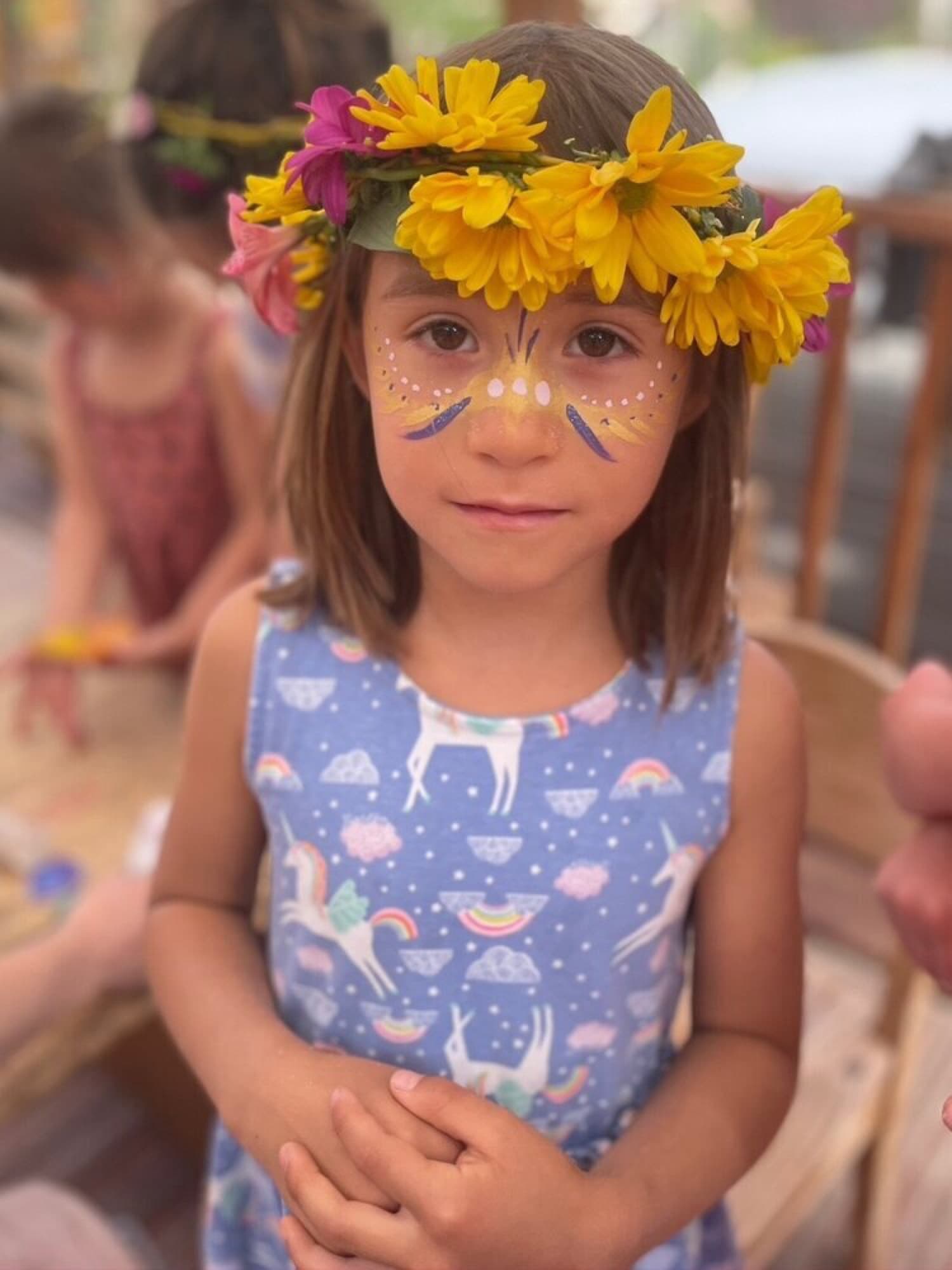 A child crowned with fresh flowers