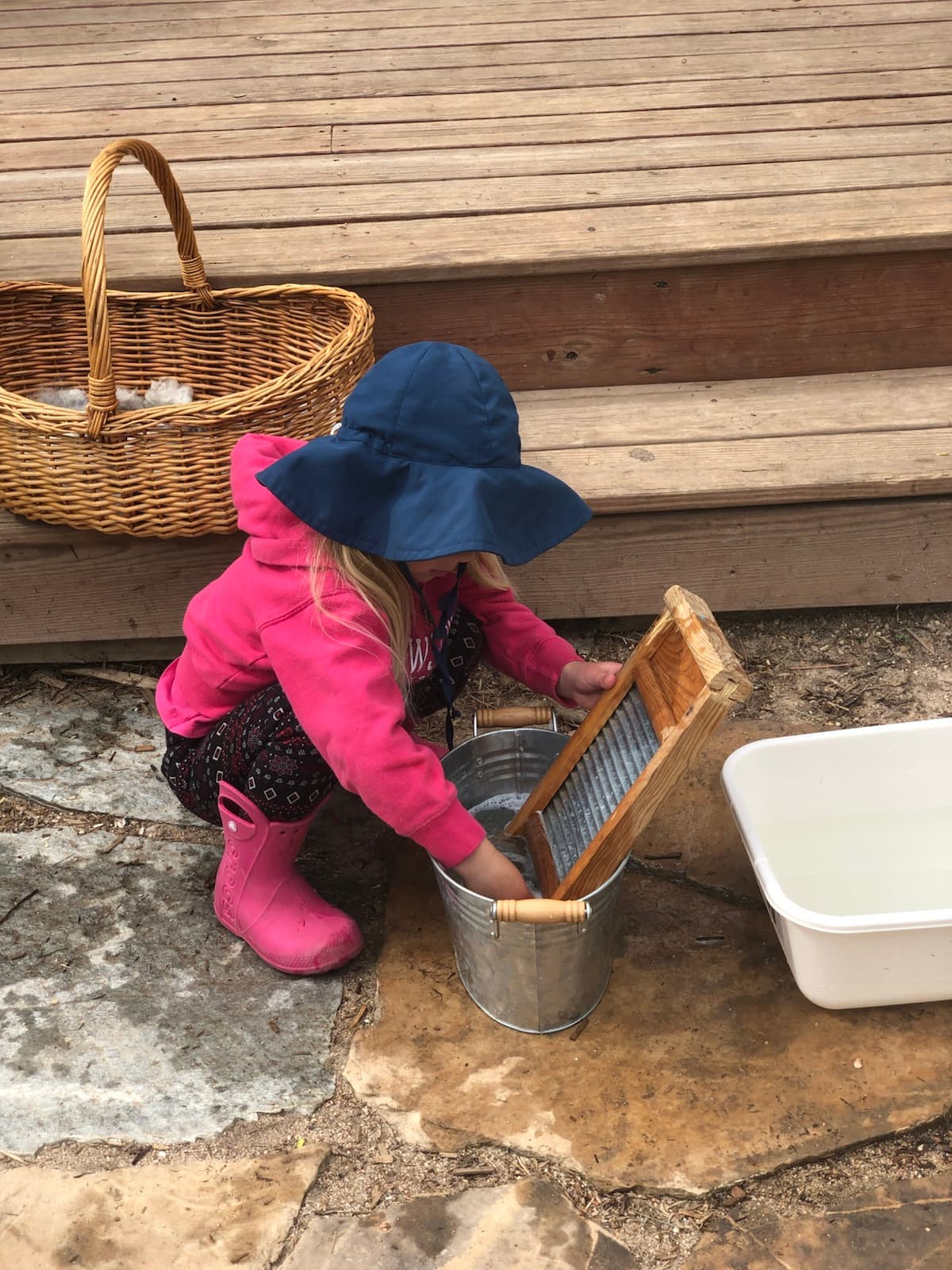 Washing up at the washboard, sleeves pushed high